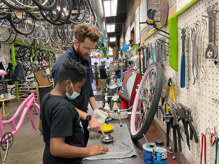 Teaching how to make bike repairs at Street Collective